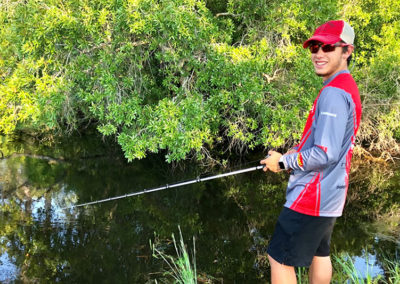 Young boy fishing.